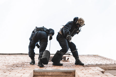 Two commandos train at the base. Climbers. SWAT, police, counterterrorism concept. Mixed mediaの写真素材