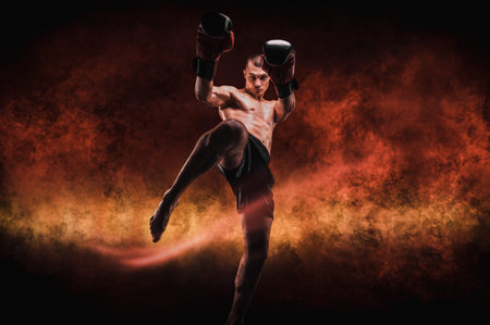 Image of a kickboxer in a fiery arena. Knee kick. Mixed martial arts. Sports concept.