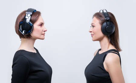 Image of two attractive women with headsets. TV shopping concept. Mixed mediaの写真素材