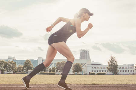 Image of a girl standing on the start line of the track. Running concept. Mixed mediaの写真素材