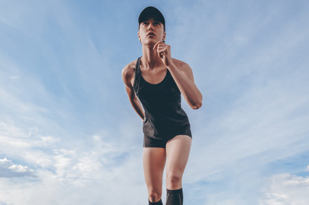 Image of a girl standing on the start line of the track. Running concept. Mixed media