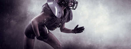 Image of a girl in the uniform of an American football team player. She runs with the ball against the background of light spots. Sports concept. Shoulders pads. Mixed mediaの写真素材