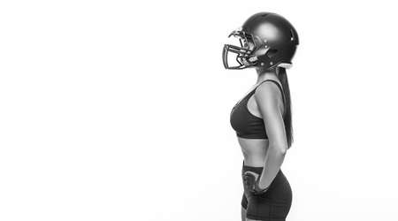 Black and white images of a sports girl in the uniform of an American football team player. Sports concept. White background. Mixed mediaの写真素材