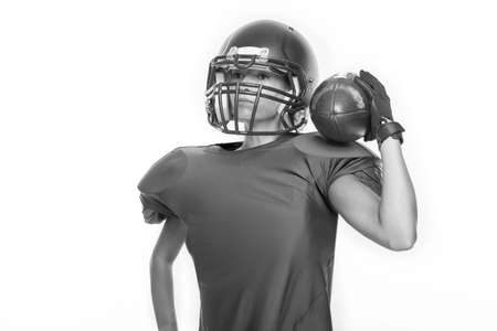 Black and white images of a sports girl in the uniform of an American football team player. Sports concept. White background. Mixed mediaの写真素材