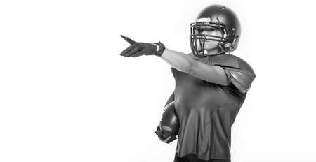 Black and white images of a sports girl in the uniform of an American football team player. Sports concept. White background. Mixed mediaの写真素材