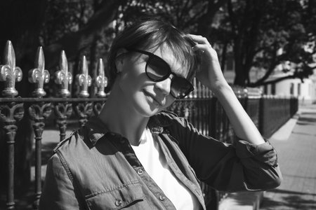 Portrait of a stylish woman in sunglasses. Happiness, freedom and carelessness. Tourism concept