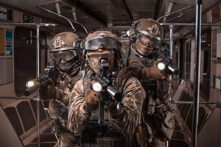 Soldiers of a special anti-terrorist unit storm a railway carriage in the subway. Special operation concept. Mixed mediaの写真素材