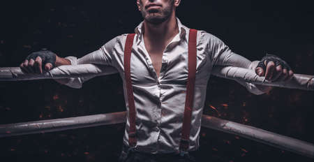 No name image of a bearded man in a white shirt and suspenders in the ring. The concept of fist underground fights. Mixed mediaの写真素材