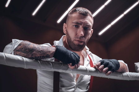 Images of a bearded man in a white shirt and red suspenders in the ring. The concept of fist...