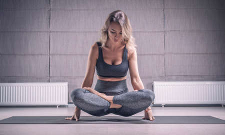Image of an adult woman in yoga place. The concept of yoga and spiritual practices. Training and posing. Mixed mediaの写真素材