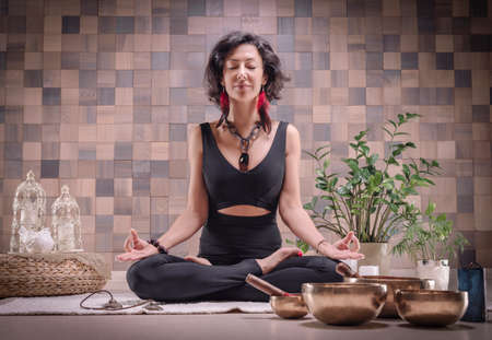 Image of an adult woman in yoga place. Meditation. The concept of yoga and spiritual practices. Mixed mediaの写真素材