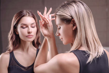 Image of intertwining female hands. Female support concept. Women's Club. Exchange of energy flows. Mixed mediaの写真素材