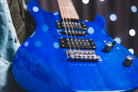 Image of a blue electric guitar close-up. The concept of tuning and repairing musical instruments. Mixed mediaの写真素材