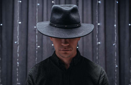 Image of an adult man wearing a black hat. Gangster concept. Mixed mediaの写真素材
