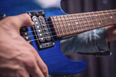 Image of the hands of a musician playing the electric guitar. The concept of concerts and entertainment events. Mixed mediaの写真素材