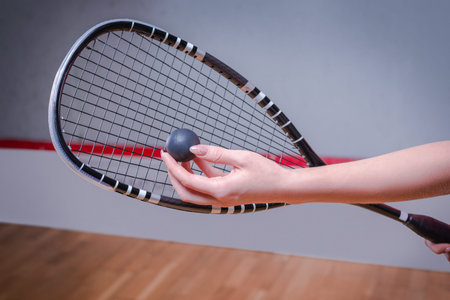 Image of a woman's hand with a squash racket. sports concept. mixed media