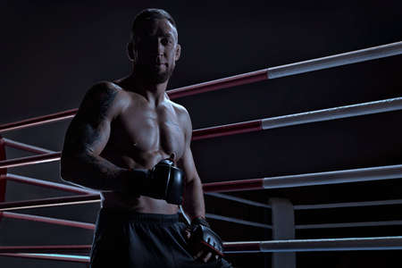Kickboxer showing thumbs up standing near the ring. sports competitions. Fight night. The concept of mixed martial arts. MMAの写真素材
