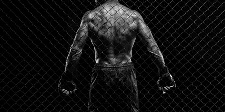 Black and white image of a man in a boxing cage. The concept of sports, Muay Thai, martial arts.