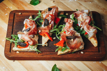 Culinary Delight: Prosciutto Bruschetta Trio on Cutting Boardの写真素材