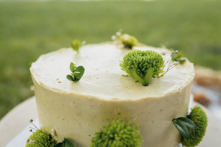 Elegant White Cake Adorned With Green Floral Detailsの写真素材