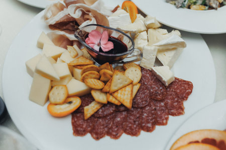 Cheese platter artfully arranged with crackers and cured meats