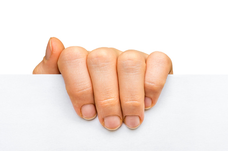 Woman's hand holding white blank paper isolated on white backgroundの写真素材