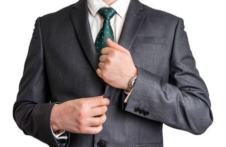 Business man adjusts his tuxedo - isolated on white backgroundの写真素材