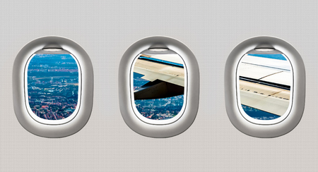 View of wing and big city from airplane windows - flight conceptの写真素材