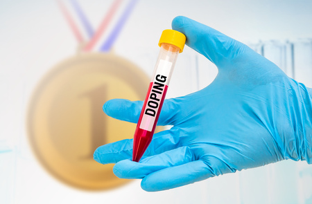 Scientists hand holding a test-tube with blood sample for DOPING testの写真素材