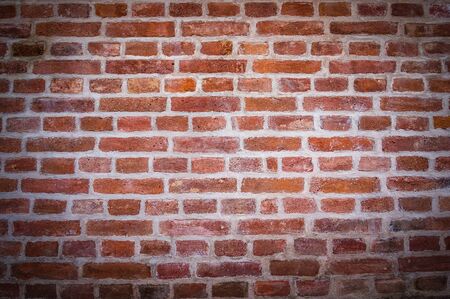 Red brick wall texture background with vignetted cornersの写真素材