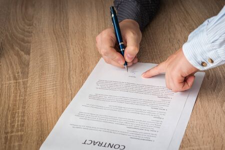 Businessman is pointing where to sign contract - business conceptの写真素材