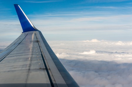 Looking through window airplane during flight in wingの写真素材