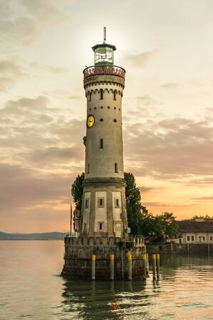 Lighthouse and sunset in harbor of Lindau in lake Constance, Germanyの写真素材