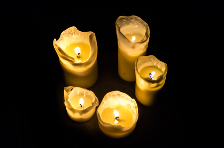 Five candles at night isolated in the dark backgroundの写真素材