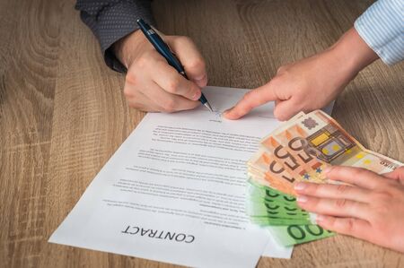 Businessman is pointing where to sign contract - business conceptの写真素材