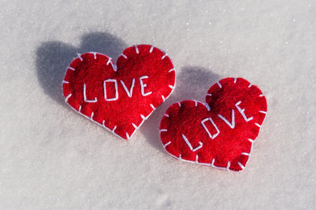Beautiful hearts on a snow backgroud - always togetherの写真素材