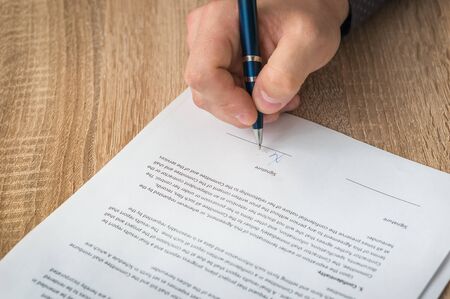 Businessman is signing a contract - business conceptの写真素材