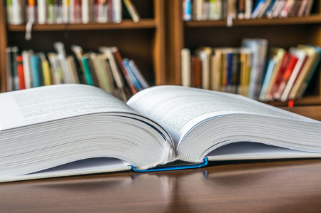 Open book on the table in libraryの写真素材