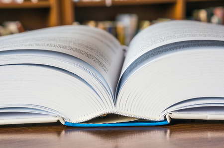 Open book on the table in libraryの写真素材