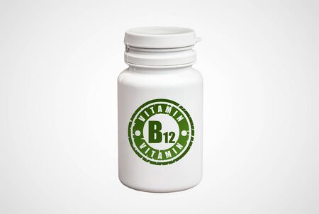 Bottle of pills with vitamin B12 on white backgroundの写真素材
