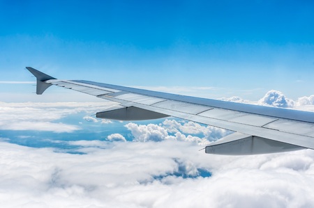 Looking through window airplane during flight in wingの写真素材