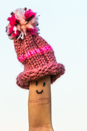 Happy finger with cap on blue skyの写真素材