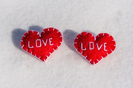 Beautiful hearts on a snow backgroud - always togetherの写真素材