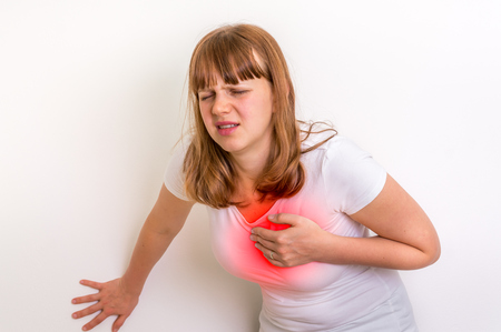 Woman having chest pain heart attackの写真素材
