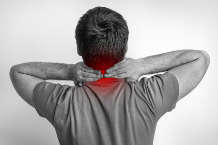 Man with muscle injury having pain in his neck - black and white photoの写真素材