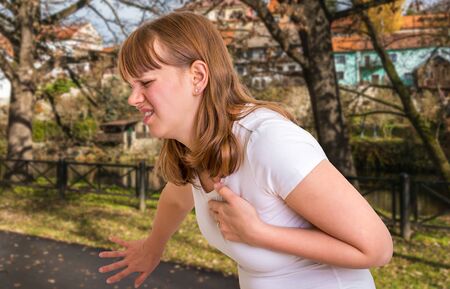 Woman having heart attack in autumn park - body painの写真素材