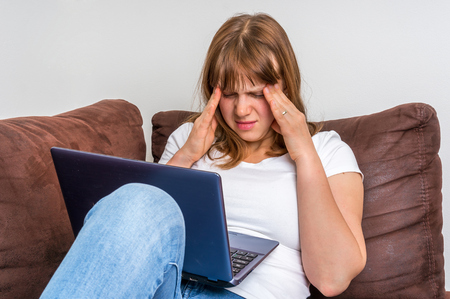 Woman with laptop having tired and sore eyes - eyes painの写真素材