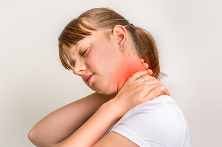 Woman with muscle injury having pain in her neckの写真素材