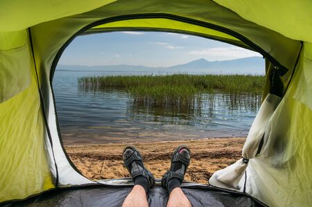 View from inside a tent on a beautiful pond in Macedoniaの写真素材