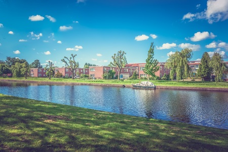 Houses next to the channel, one of the beautiful streets in Netherlands - retro and vintage styleの写真素材